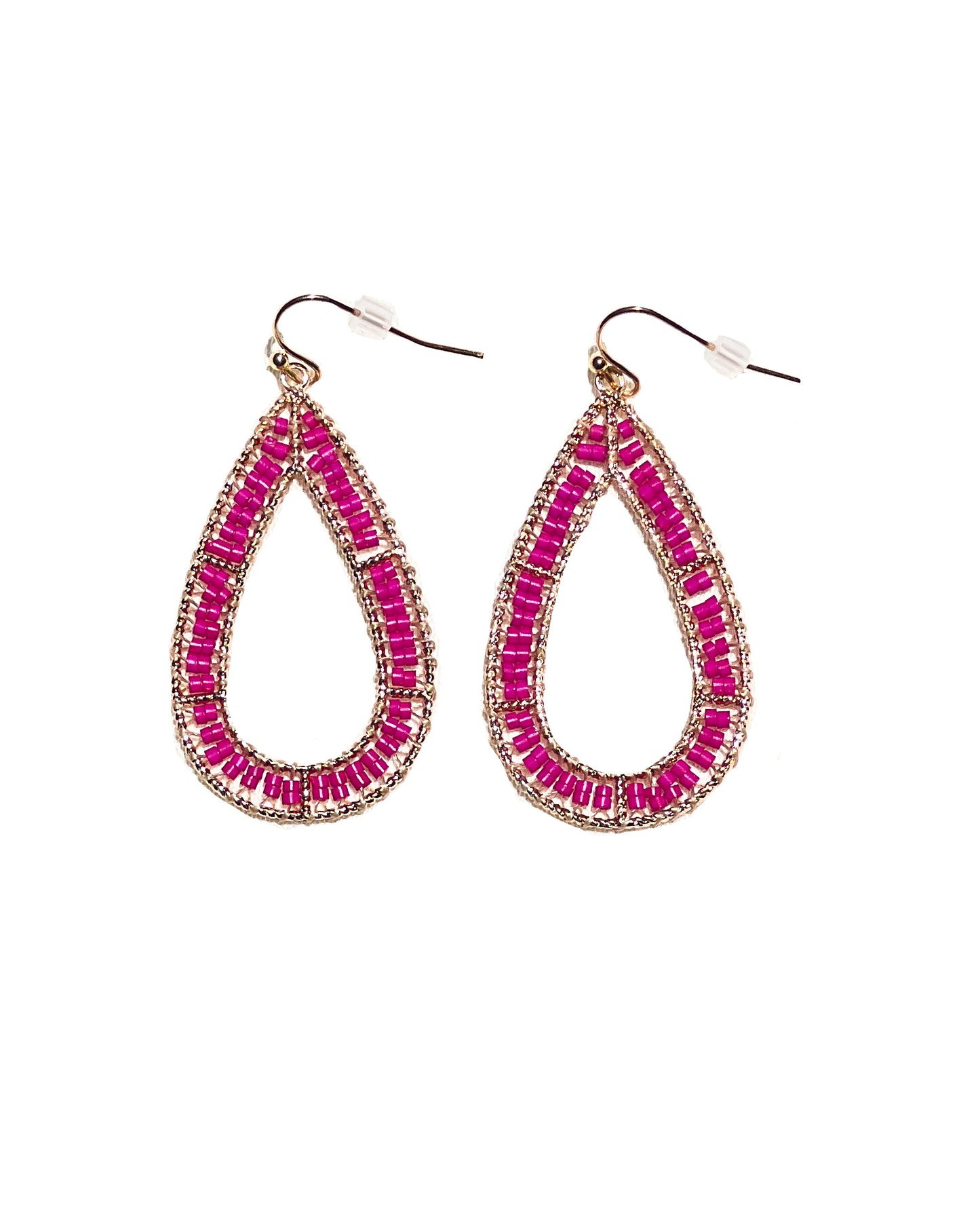 A close-up detail of hot pink earrings with beaded material. Has an oval shape and has plastic backing.