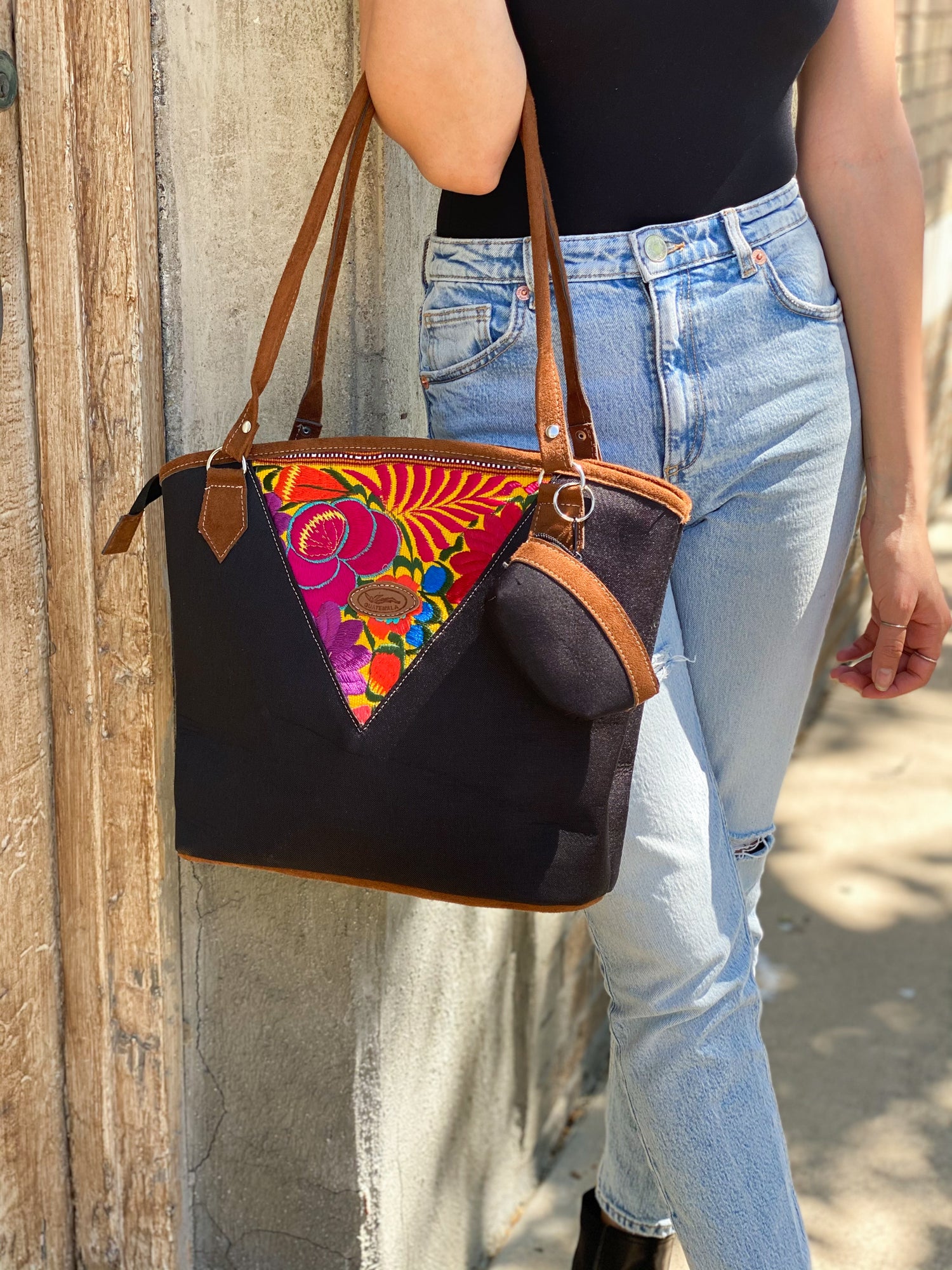 Black embroidery tote bag with floral detail. Handmade in Guatemala with Handwoven intricate fabric. The perfect laptop or beach bag.