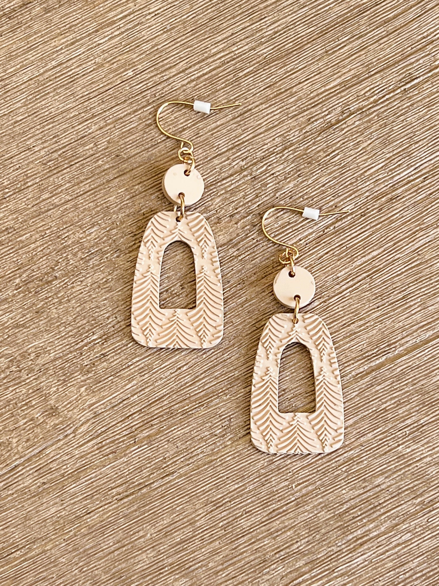 Nothing can pair better than these Cream Geometric Drop Earrings! Lightweight with a unique shape making them the perfect compliment to your look.    Clay Material  2'' Long Plastic Backing Made in China.