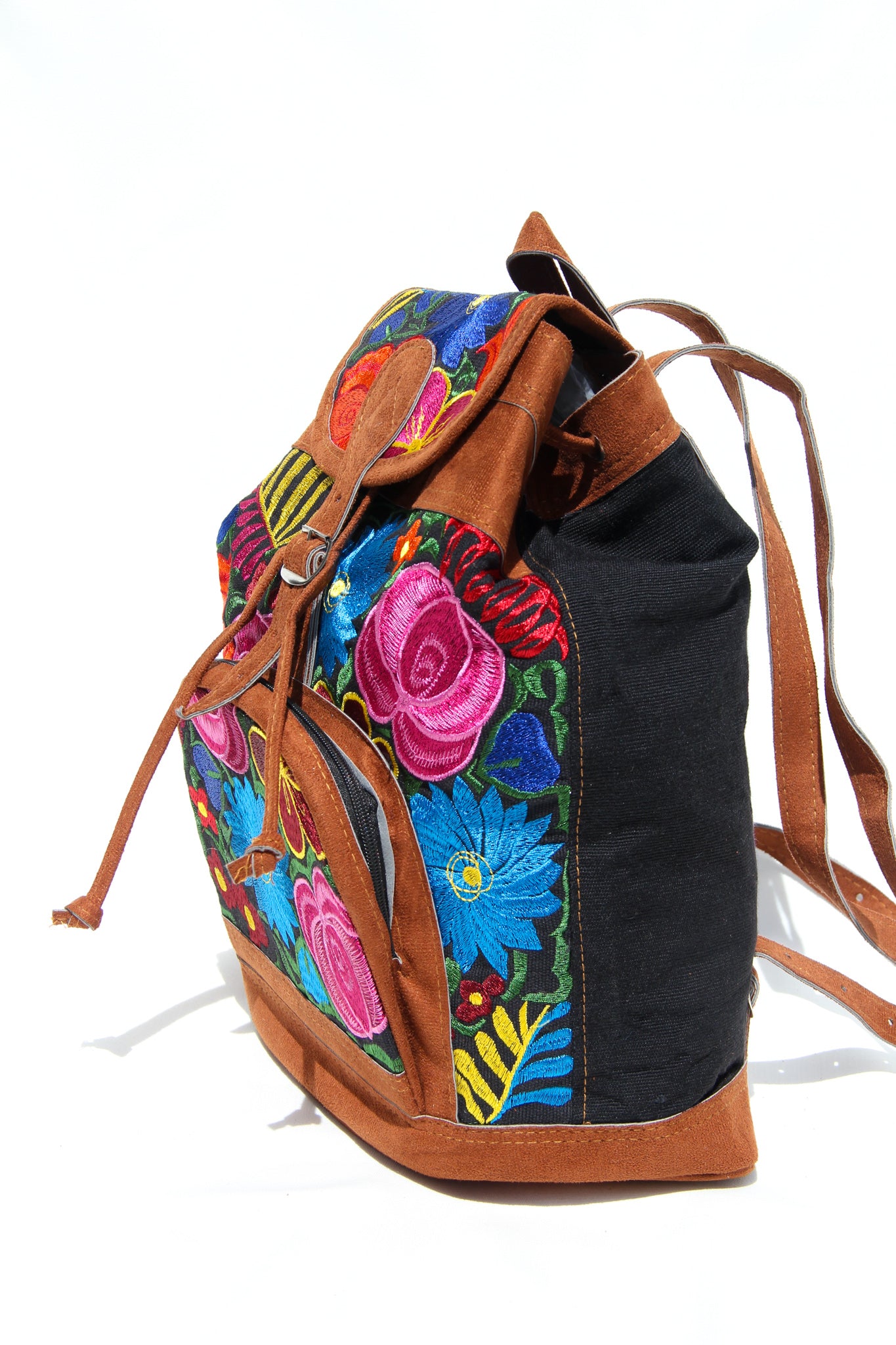 colorful huipil floral embroidery backpack with black woven fabric and faux suede contrast with adjustable straps and front buckle closure with front zipper pocket the prefect travel, hiking or beach bag unique bag great for back to school take this bag on your next destination boho bag and hippie style bag a great standout accessories made in Guatemala