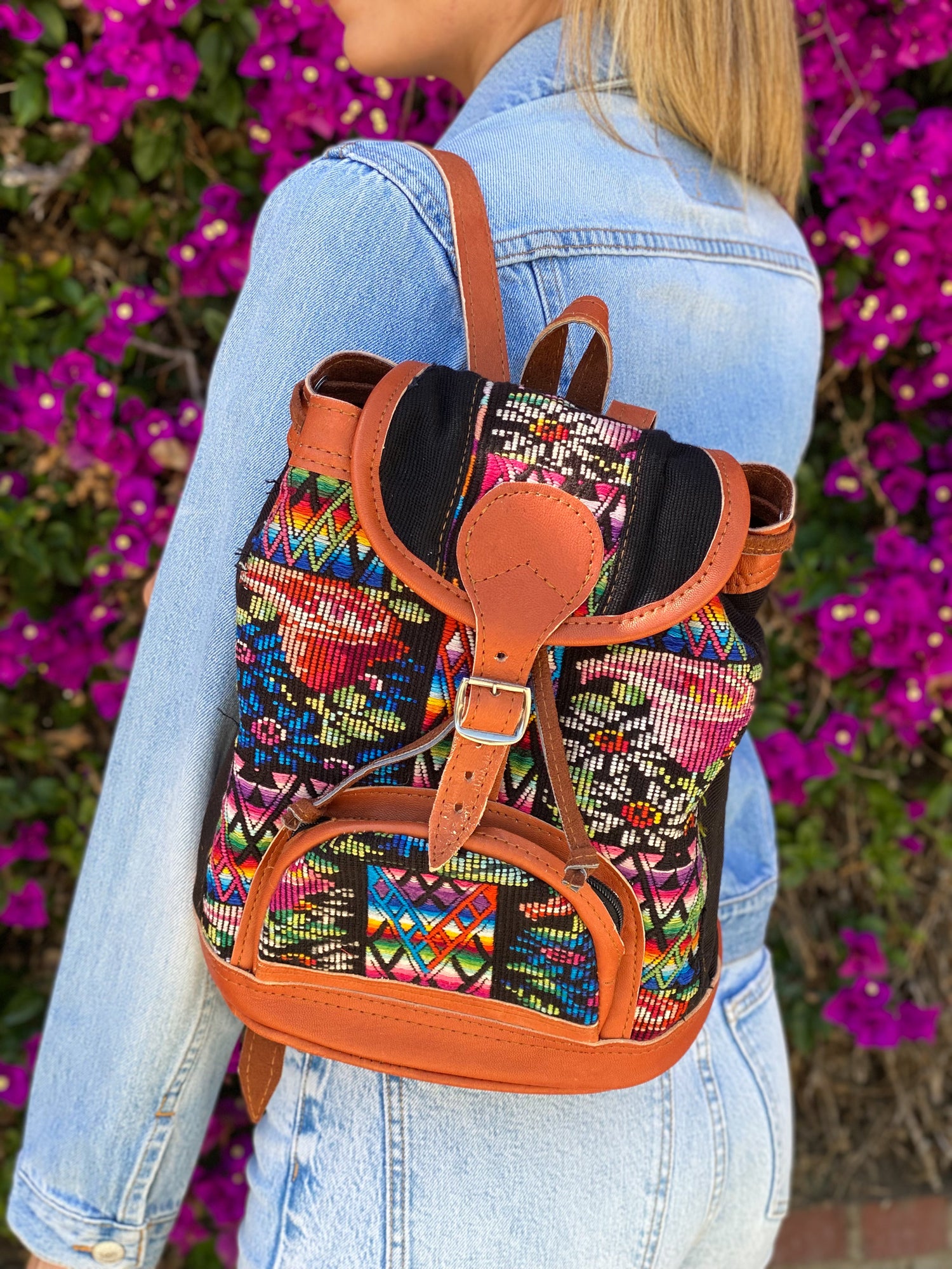 MIni leather huipil backpack hand woven with colorful embroidery and adjustable leather straps with front belt buckle closure and front zipper pocket perfect for hiking or beach trip handmade in Guatemala