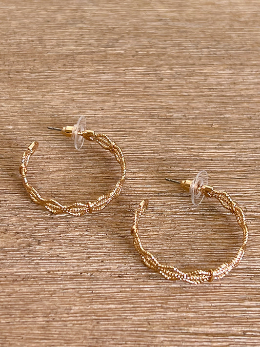 Complete your look in these Gold Mini Hoop Earrings! This pair is the perfect minimal look that will take your outfit from simple to chic.   Gold Hoops 1 1/4'' Long Plastic Backing Made in China.