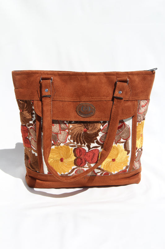 Huipil floral embroider handbag with faux suede shoulder straps and contrast details with a front pocket and top zipper zipper closure to prevent anything from falling out while using its beautiful yellow, brown and dark tones make this bag unique Perfect for shopping, taking to the beach or for your next vacation enough room to fit a laptop or any essentials for travel the perfect boho bag with two large back zipper pockets for extra compartments