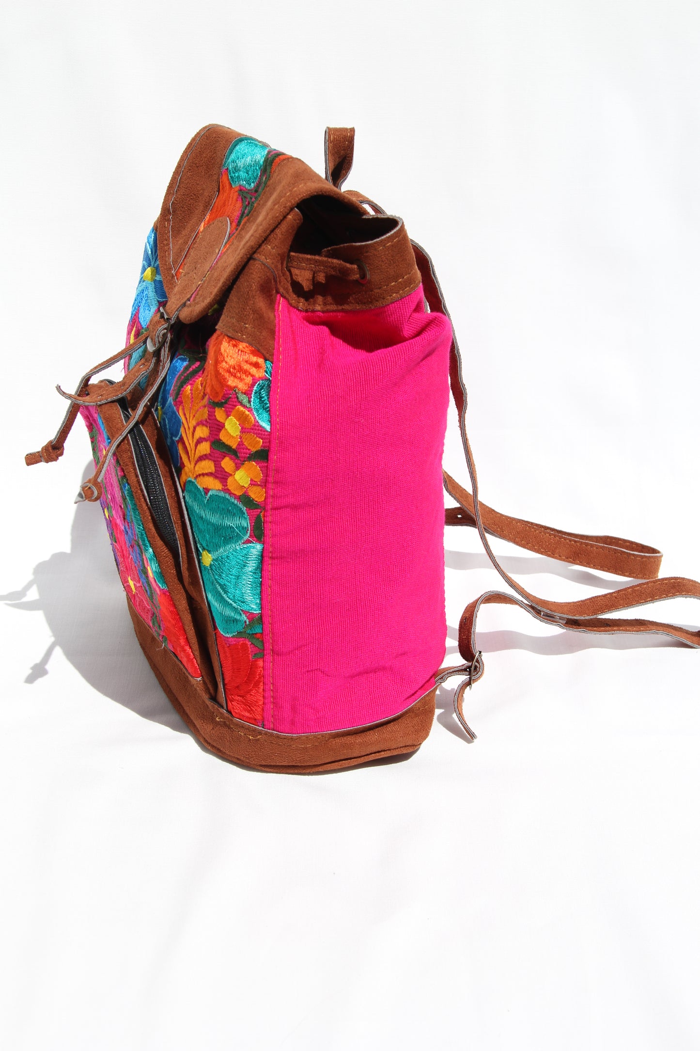 colorful huipil floral embroidery backpack with pink woven fabric and faux suede contrast with adjustable straps and front buckle closure with front zipper pocket the prefect travel, hiking or beach bag unique bag great for back to school take this bag on your next destination boho bag and hippie style bag a great standout accessories made in Guatemala