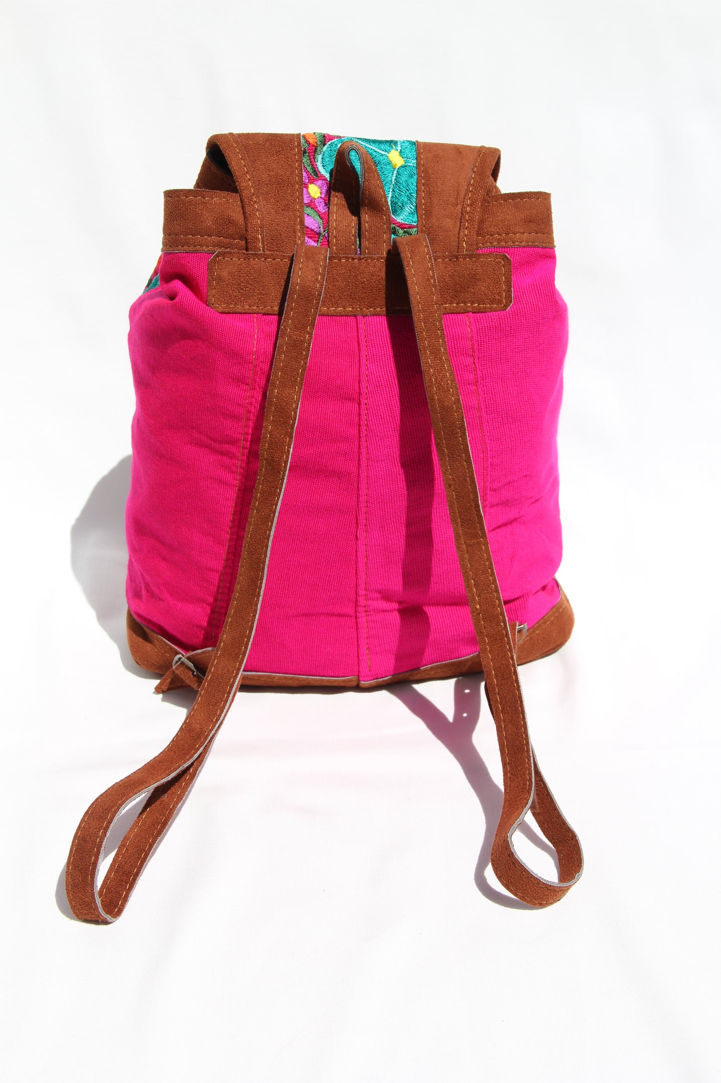 colorful huipil floral embroidery backpack with pink woven fabric and faux suede contrast with adjustable straps and front buckle closure with front zipper pocket the prefect travel, hiking or beach bag unique bag great for back to school take this bag on your next destination boho bag and hippie style bag a great standout accessories made in Guatemala