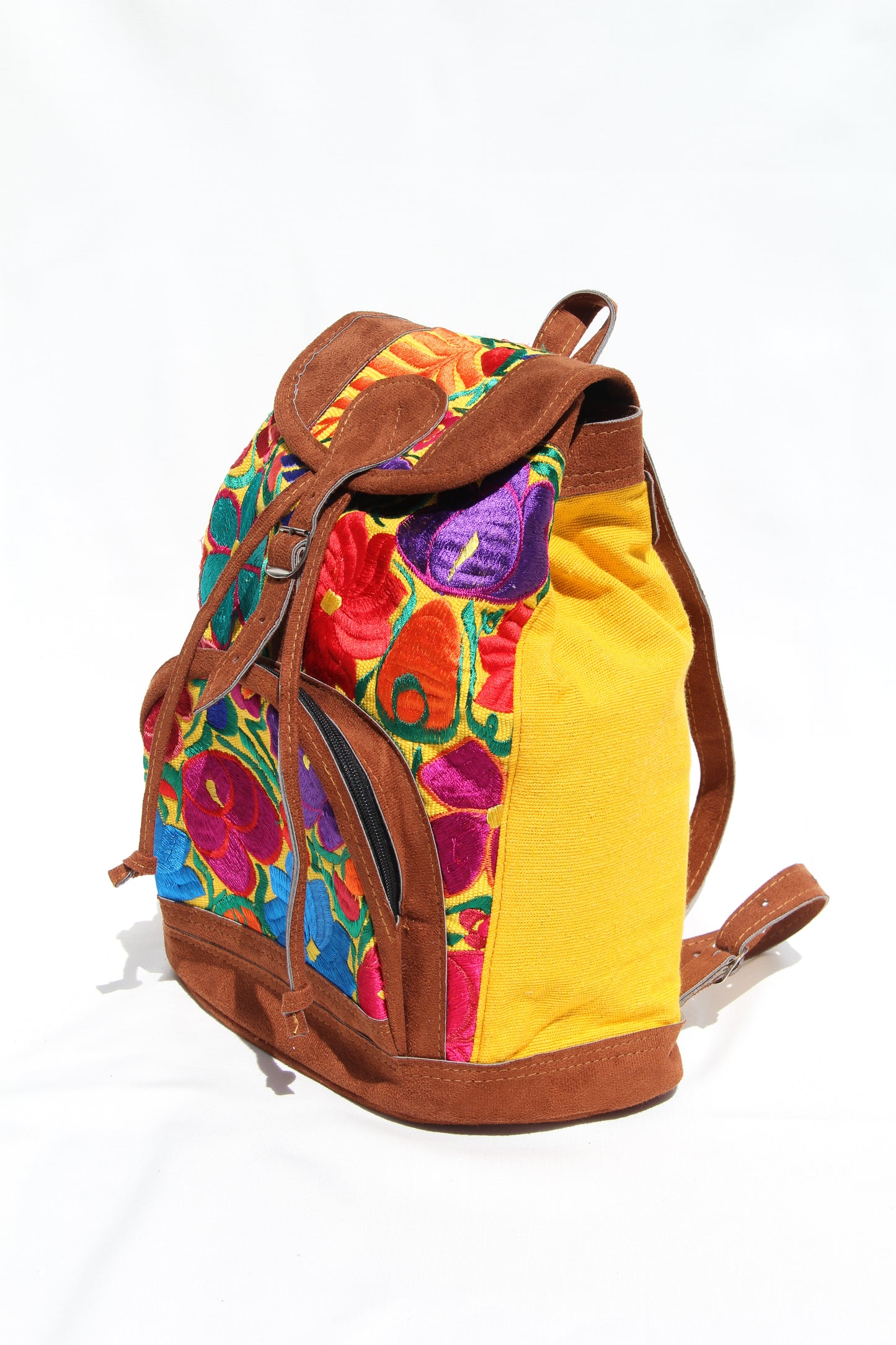 colorful huipil floral embroidery backpack with yellow woven fabric and faux suede contrast with adjustable straps and front buckle closure with front zipper pocket the prefect travel, hiking or beach bag unique bag great for back to school take this bag on your next destination boho bag and hippie style bag a great standout accessories made in Guatemala