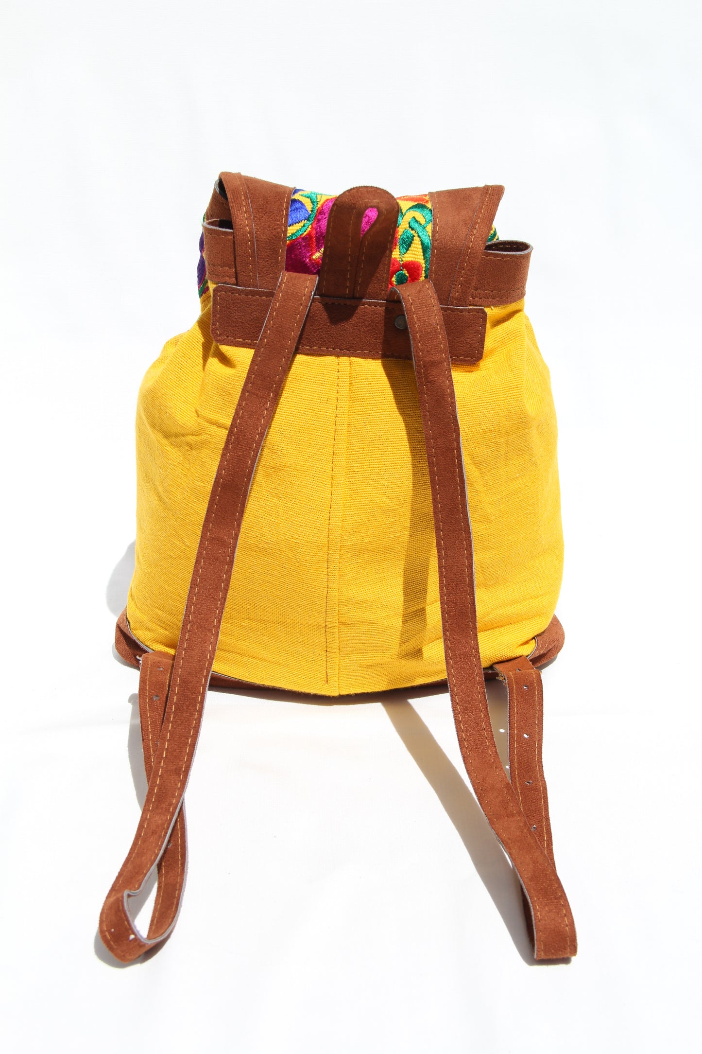 colorful huipil floral embroidery backpack with yellow woven fabric and faux suede contrast with adjustable straps and front buckle closure with front zipper pocket the prefect travel, hiking or beach bag unique bag great for back to school take this bag on your next destination boho bag and hippie style bag a great standout accessories made in Guatemala