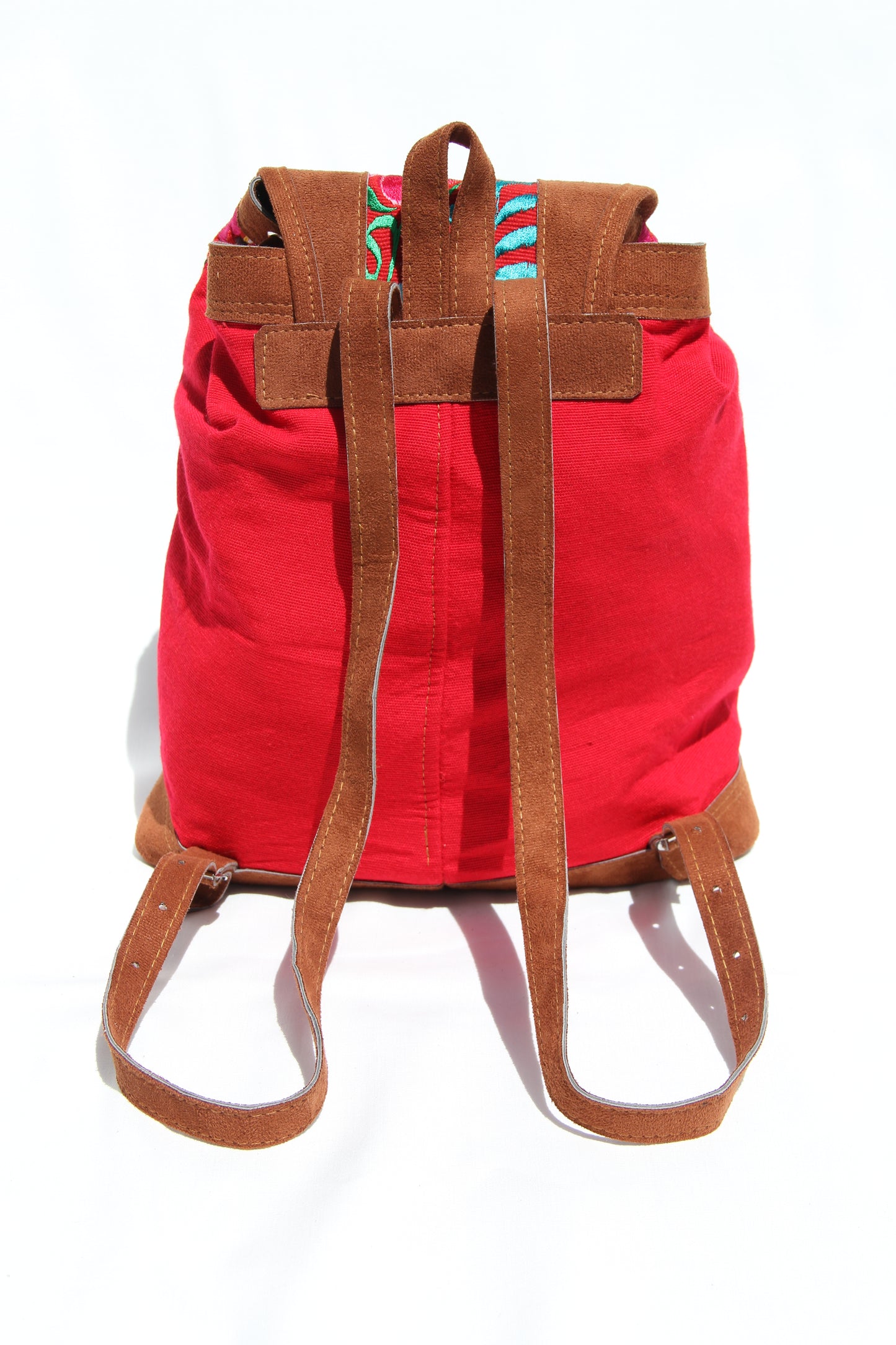 colorful huipil floral embroidery backpack with red woven fabric and faux suede contrast with adjustable straps and front buckle closure with front zipper pocket the prefect travel, hiking or beach bag unique bag great for back to school take this bag on your next destination boho bag and hippie style bag a great standout accessories made in Guatemala