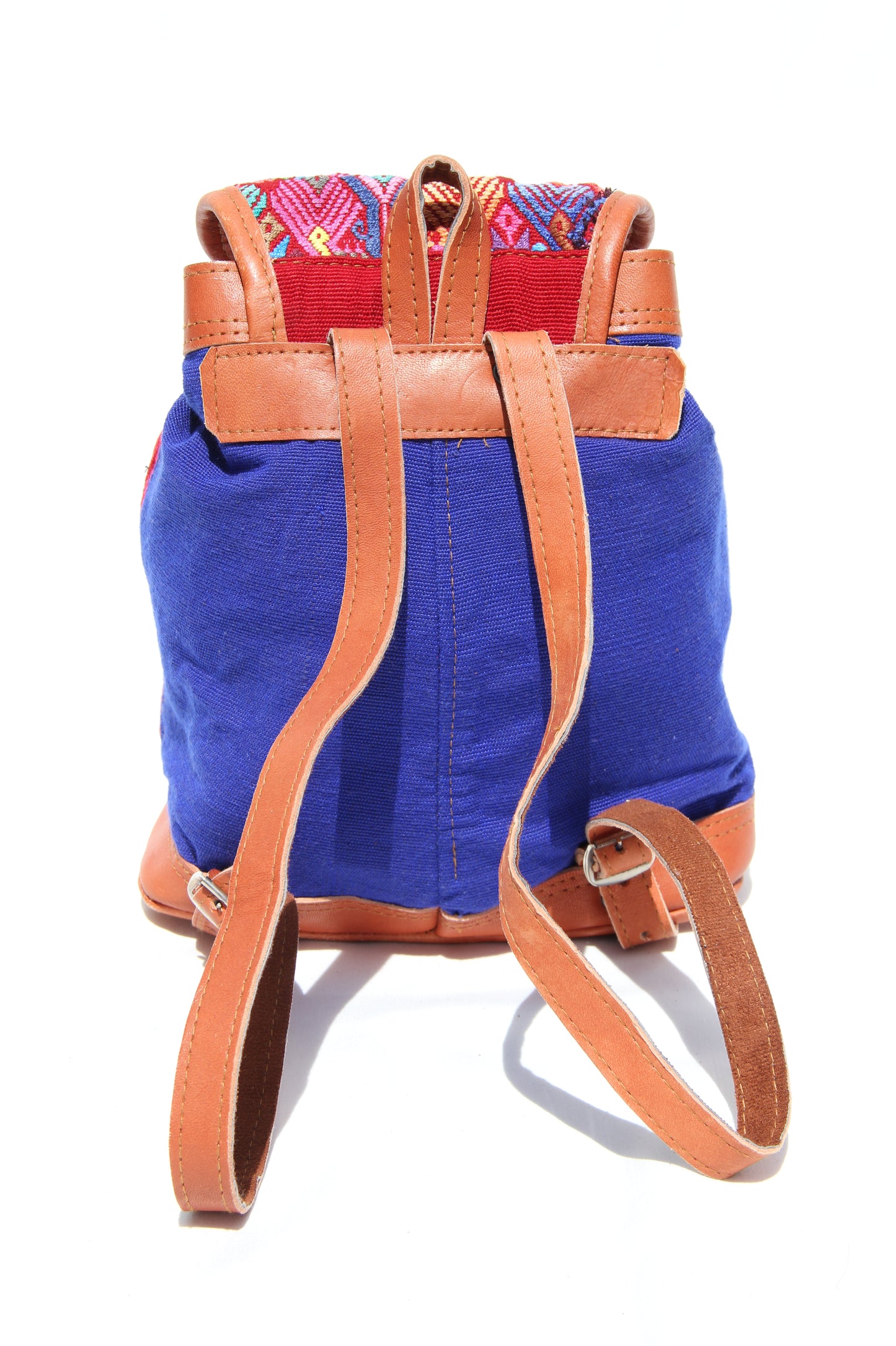 MIni leather huipil backpack hand woven with colorful embroidery and adjustable leather straps with front belt buckle closure and front zipper pocket perfect for hiking or beach trip