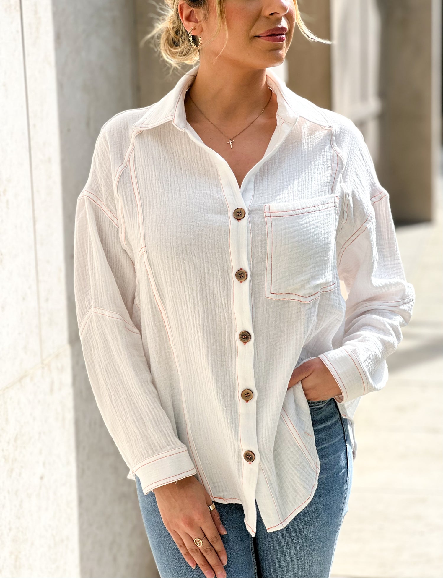  The model is wearing a white button up shirt the fabric is lightweight with an oversized fit and a beautiful back tie detail long sleeves with a front patch pocket a very timeless piece perfect for the beach to be worn as a cover up 100 % Cotton Model is wearing a Small 