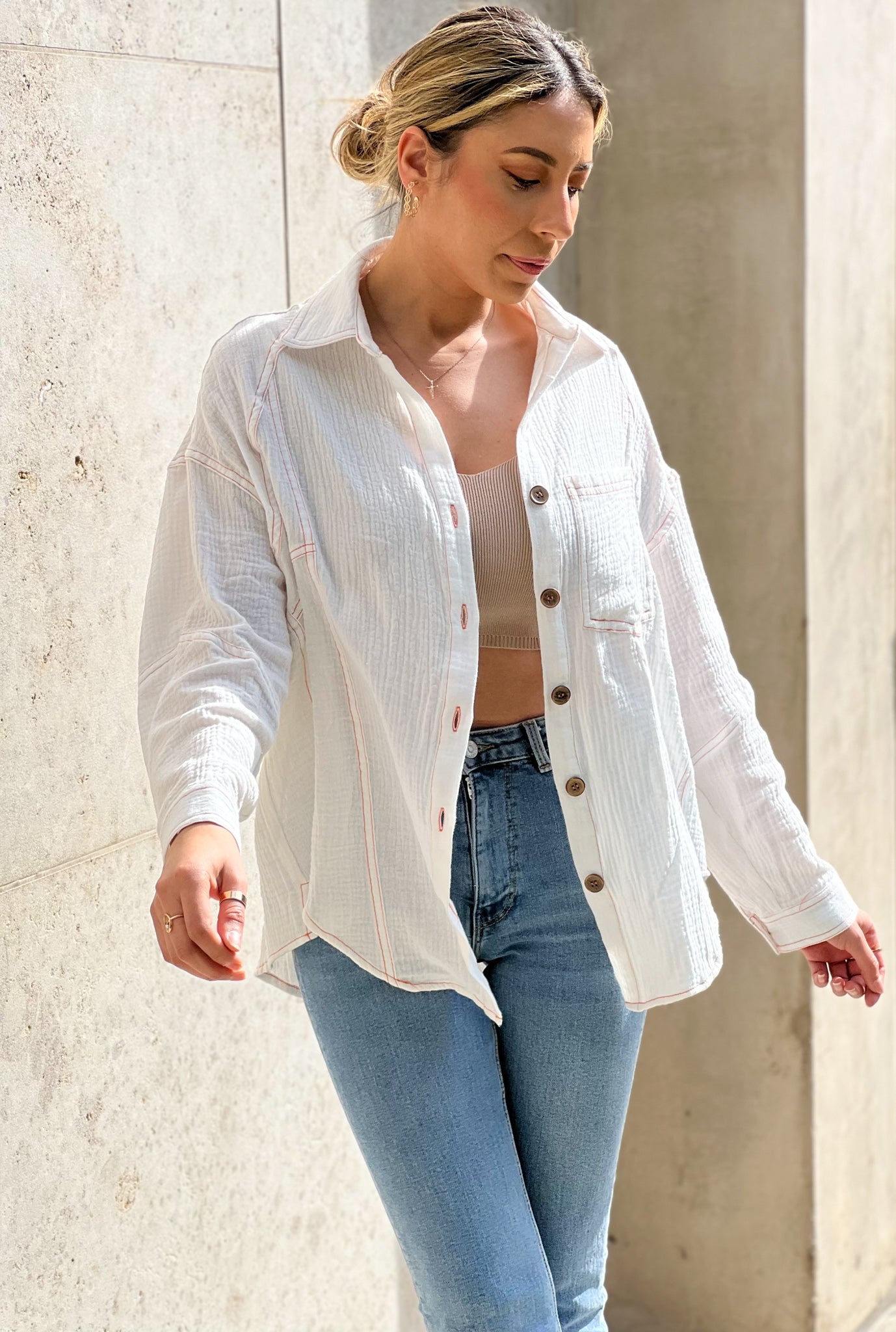 The model is wearing a white button up shirt the fabric is lightweight with an oversized fit and a beautiful back tie detail long sleeves with a front patch pocket a very timeless piece perfect for the beach to be worn as a cover up 100 % Cotton Model is wearing a Small