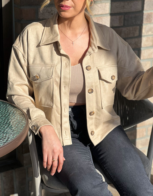 The Running Late Cropped Jacket is perfect for those hectic days when you need to be the out the door ASAP, but still look fabulous!!! Soft faux suede, boxy fit, full button placket, with a collared neckline and buttoning flap pockets.   Beige 95% Polyester and 5% Spandex Model wearing small 
