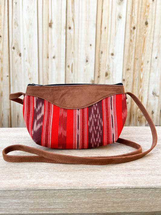Our "Quetzal Crossbody Bags" are handmade in Guatemala. It's vibrant and colorful textiles make them a perfect and unique standout piece. A perfect size for your essentials only. Handwoven Intricate Fabric. Faux Suede Straps. Zipper Closure. Fully Lined. Handmade in Guatemala